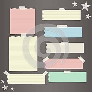 Colorful striped paper, copybook, notebook sheets for note or message stuck with sticky, adhesive tape, stars on dark