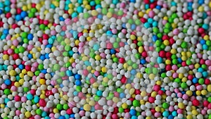 Colorful sugar balls filmed with movement