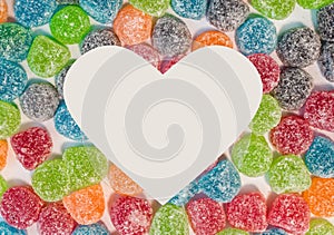 Colorful sugar jelly sweets background with white heart shaped s