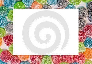 Colorful sugar jelly sweets background with white square space f