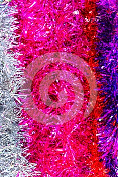 Colorful Sukkot or Sukkos or Christmas tinsel. New year`s fluffy gold, purple, silver, yellow, pink tinsel.