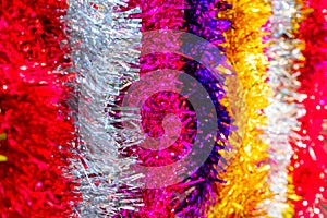 Colorful Sukkot or Sukkos or Christmas tinsel. New year`s fluffy gold, purple, silver, yellow, pink tinsel. photo