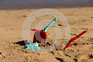 Colorful Summer Children`s beach toys on a sandy beach.