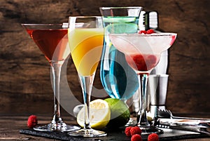 Colorful summer cocktails. Cold alcoholic beverages and drinks: mimosa, cosmopolitan, raspberry margarita and blue hawaii on