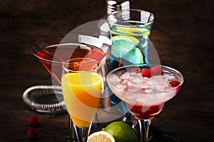 Colorful summer cocktails. Cold alcoholic beverages and drinks: mimosa, cosmopolitan, raspberry margarita and blue hawaii on