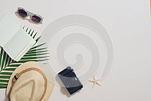 Colorful summer holidays fashion flat lay - straw hat, camera, sunglasses, sea shells on ligh background