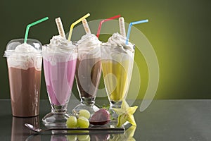 Colorful summer milkshake on bright background with fruits photo