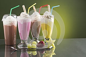 Colorful summer milkshake on bright background with fruits photo