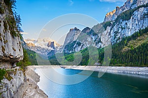 Colorful summer panorama of Vorderer Gosausee lake with Dachstein glacier on background.