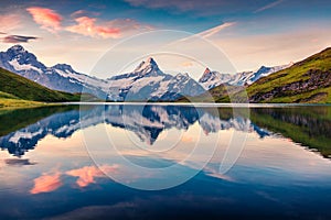 Colorful summer sunrise on Bachalpsee lake with Schreckhorn and