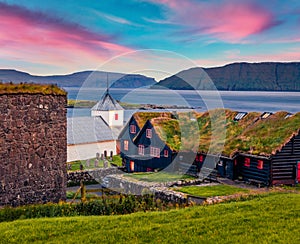 Colorful summer sunrise Hestur Island. Amazing morning view of Kirkjubour village, Faroe Islands, Kingdom of Denmark, Europe.  Tra