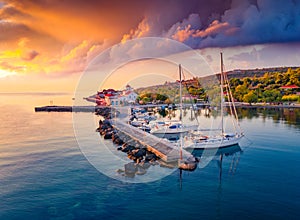 Colorful summer sunrise in St. Georgios port.