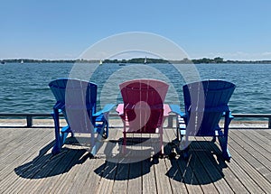 Colorful sunbeds on the pier at the sea on a sunny day