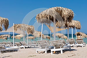 Colorful sunbeds and umbrellas at the beach