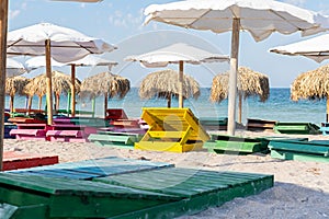 Colorful sunbeds and umbrellas at the beach