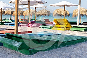 Colorful sunbeds and umbrellas at the beach