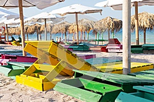 Colorful sunbeds and umbrellas at the beach