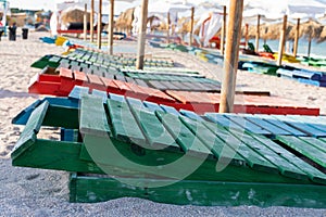 Colorful sunbeds and umbrellas at the beach