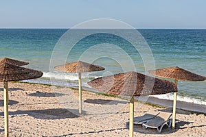 Colorful sunbeds and umbrellas at the beach