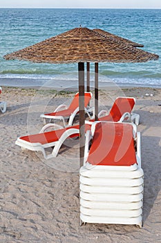 Colorful sunbeds and umbrellas at the beach