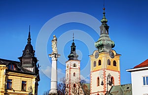 Colorful sunlit towers of main square Banska Bystrica Slovakia