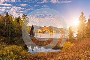 Colorful sunny autumn landscape with golden colored trees