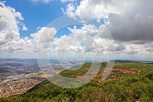 Colorful sunny landscape view on Netufa valley and beautiful Turan mountain range with olive tree plantation grow