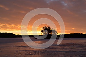 Colorful sunrise with clouds in the sky and frozen lake