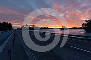 Colorful sunrise with clouds in the sky and frozen lake