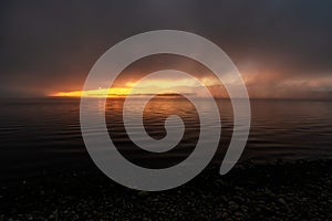 Colorful sunrise and dark misty weather over the lake Liptovska Mara at Slovakia