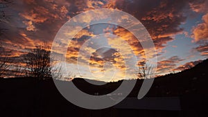 Colorful sunrise in the mountains. Panorama with beautiful clouds.