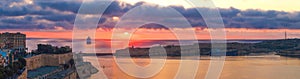 Colorful sunrise panorama with cruise ship in bay