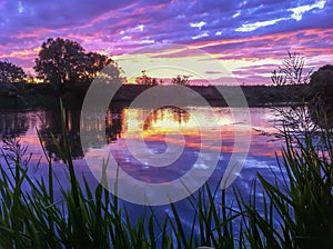 Colorful sunrise, sunset on the lake, river in summe, last rays of the sun over the horizon. Natural picturesque colors