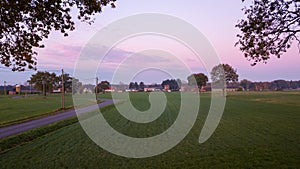 Colorful sunrise or sunset sky over a farmfield shot from high up