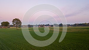 Colorful sunrise or sunset sky over a farmfield shot from high up