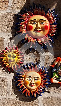 Colorful suns of glazed terracotta