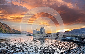 Colorful sunset against Eilean Donan Castle at Kyle of Lochalsh in the Western Highlands of Scotland