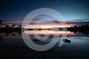 Colorful sunset cloudscape over Pine Glades Lake in Everglades National Park.