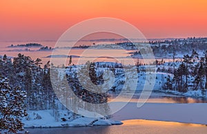 A colorful sunset on the Ladoga lake in the frost.