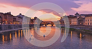 Colorful sunset with lights on Ponte Vecchio bridge in Florence, Italy