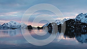 Colorful sunset in the Norwegian fjords. Cruise to Trollfjord. Snowy mountains of Lofoten Islands. Sailing in Trollfjord