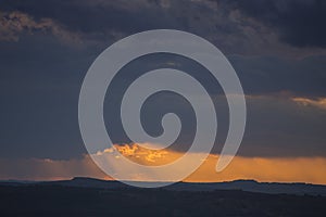 Colorful sunset over the country with lot of sun rays and clouds