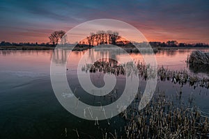 A colorful sunset over a frozen lake