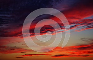 Colorful sunset over the horizont, orange, purple and pink clouds. Gorgeous Panorama twilight sky and cloud at sunset background.