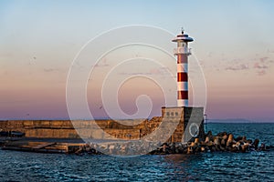 Colorful sunset over the lighthouse of the Bourgas sea shore