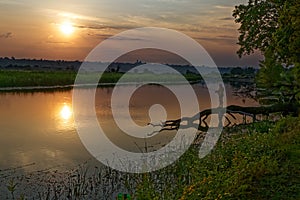 Colorful sunset over the river suburban area of central Russia