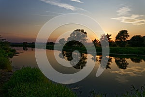 Colorful sunset over the river suburban area of central Russia