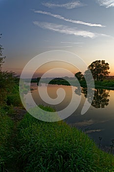 Colorful sunset over the river suburban area of central Russia