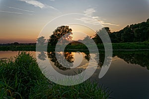 Colorful sunset over the river suburban area of central Russia