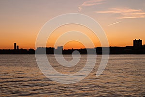 Colorful Sunset over a Silhouette of the Weehawken New Jersey Skyline along the Hudson River